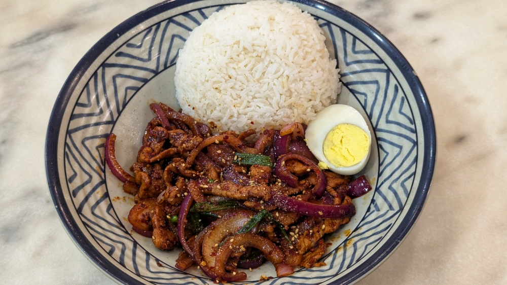 Stir-fried cumin pork slices with rice are irresistible. — Picture by Ethan Lau