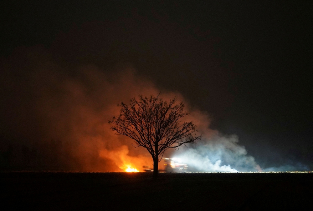 Smoke rises as a farmer uses a tractor while burning stubble in a rice field amid the ongoing air pollution at Mansa in the northern state of Punjab, India, November 11, 2024. –– Reuters pic 