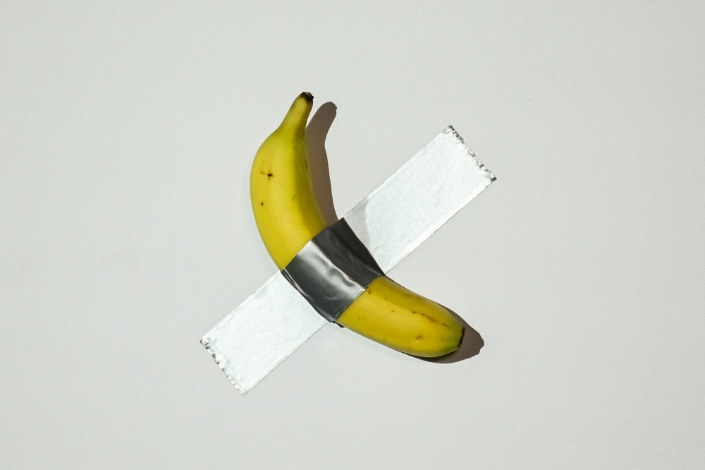 A banana artwork composed of a fresh banana stuck to a wall with duct tape is seen before being eaten by Chinese-born crypto founder Justin Sun in Hong Kong on November 29, 2024, after buying the provocative work of conceptual art by Italian artist Maurizio Cattelan at a New York auction for US$6.2 million. — AFP pic