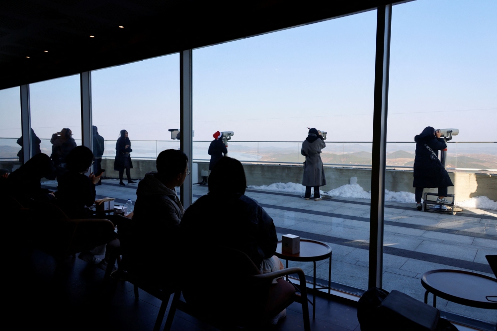 Customers sit in the new store of Starbucks at the top of the Aegibong Peak Observatory, south of the demilitarized zone (DMZ), separating the two Koreas in Gimpo, South Korea November 29, 2024. — Reuters pic  