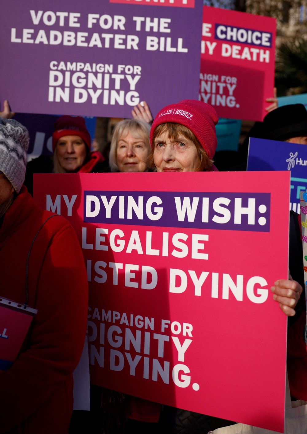 Campaigners supporting the assisted suicide bill hold placards at a demonstration outside The Palace of Westminster in central London, on November 29, 2024, as supporters and opponents of a bill to legalise euthanasia in the UK gather outside the Houses of Parliament while lawmakers debate the bill. — AFP pic