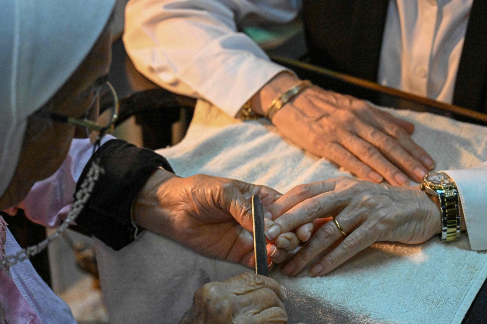 A client receives a manicure at Madam Lucie's manicure shop in downtown Cairo on November 18, 2024. — AFP pic