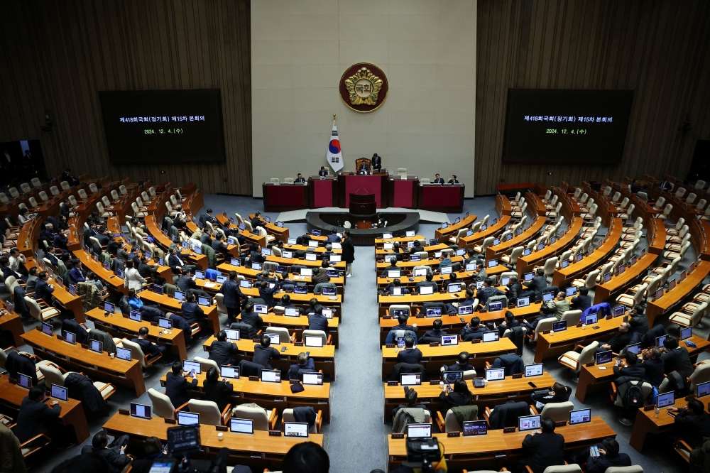 Lawmakers sit inside the hall at the National Assembly, after South Korean President Yoon Suk Yeol declared martial law, in Seoul, South Korea, December 4, 2024. — Reuters pic