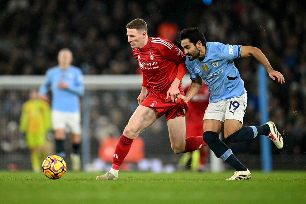 Nottingham Forest's Scottish midfielder #08 Elliot Anderson vies for the ball with Manchester City's German midfielder #19 Ilkay Gundogan during the English Premier League football match between Manchester City and Nottingham Forest at the Etihad Stadium in Manchester December 4, 2024. — AFP pic