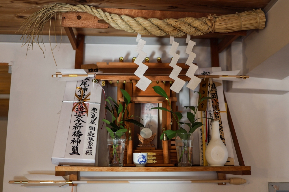 A small shrine honouring the sake gods is seen at the Toshimaya Shuzo sake brewery in Tokyo on December 4, 2024. — AFP pic