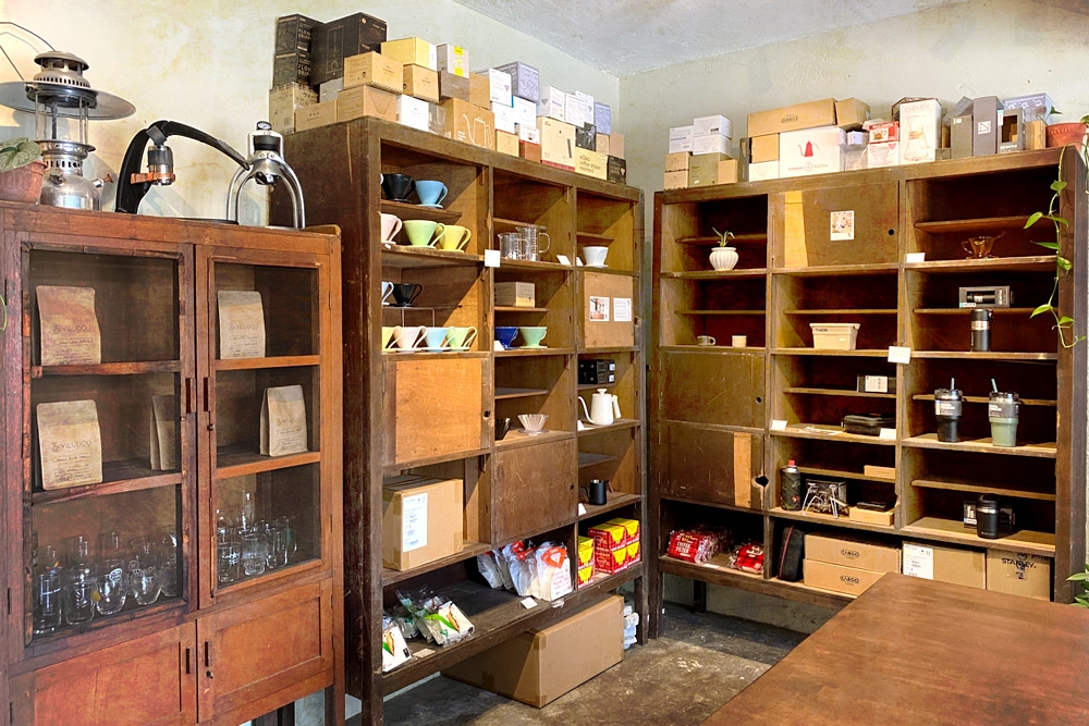 Bags of roasted beans are kept in a vintage cupboard; other shelves are filled with coffee equipment. — Picture by CK Lim