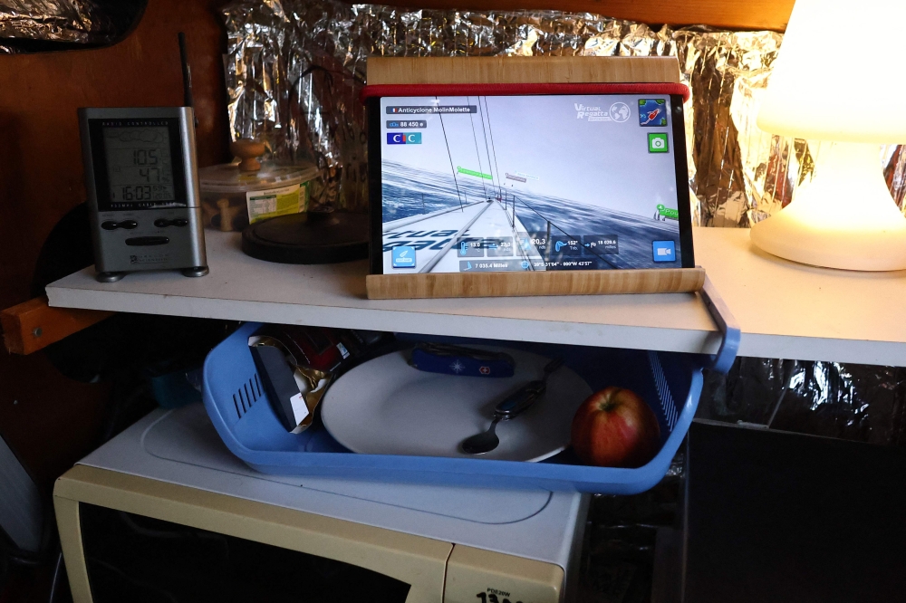 This photo shows a tablet displaying Virtual Regatta on frenchman Bernard Poitau’s boat ‘Anticylone’ as he takes part in the Vendee Globe, the solo non-stop round the world yacht race, on the Virtual Regatta sailing race simulator, spending 22 hours a day on a boat on slipways in his garden to raise charity funds in Saint-Julien-Molin-Molette, central-eastern France, on December 3, 2024. Virtual Regatta is a free online sailing game where competitors from all over the world confront each other in real-time regattas alongside major offshore races with live weather conditions. — AFP pic