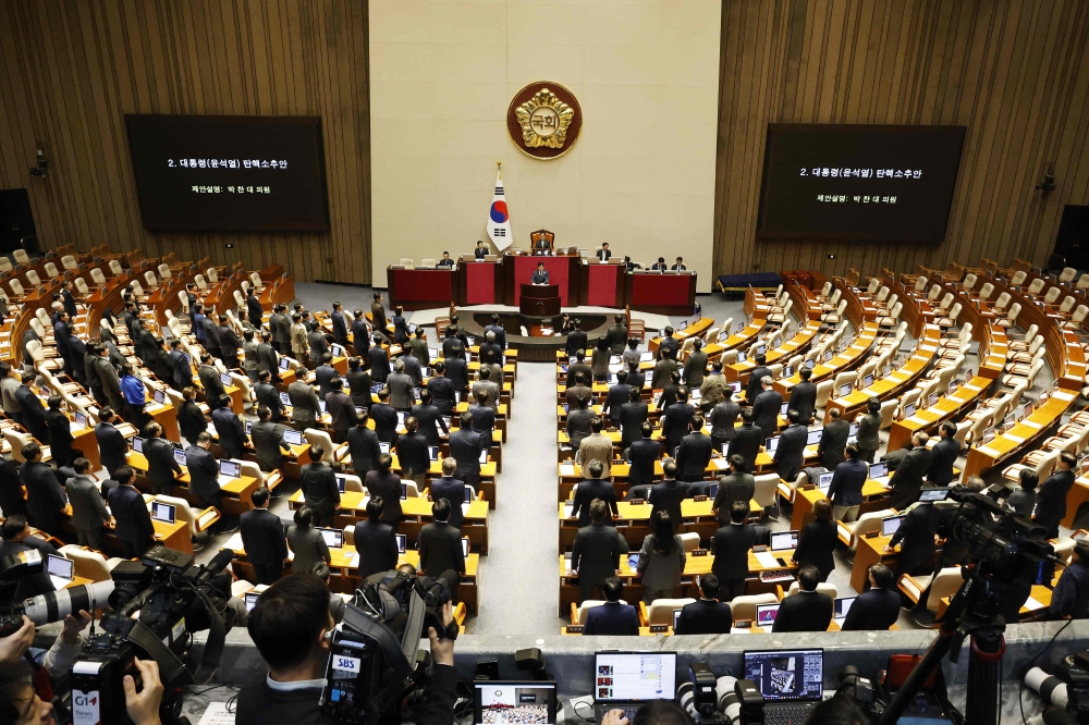 GA general view shows lawmakers in the voting chamber during the plenary session for the impeachment vote of President Yoon Suk Yeol at the National Assembly in Seoul on December 7, 2024. — Jeon Heon-kyun/Pool/AFP pic 