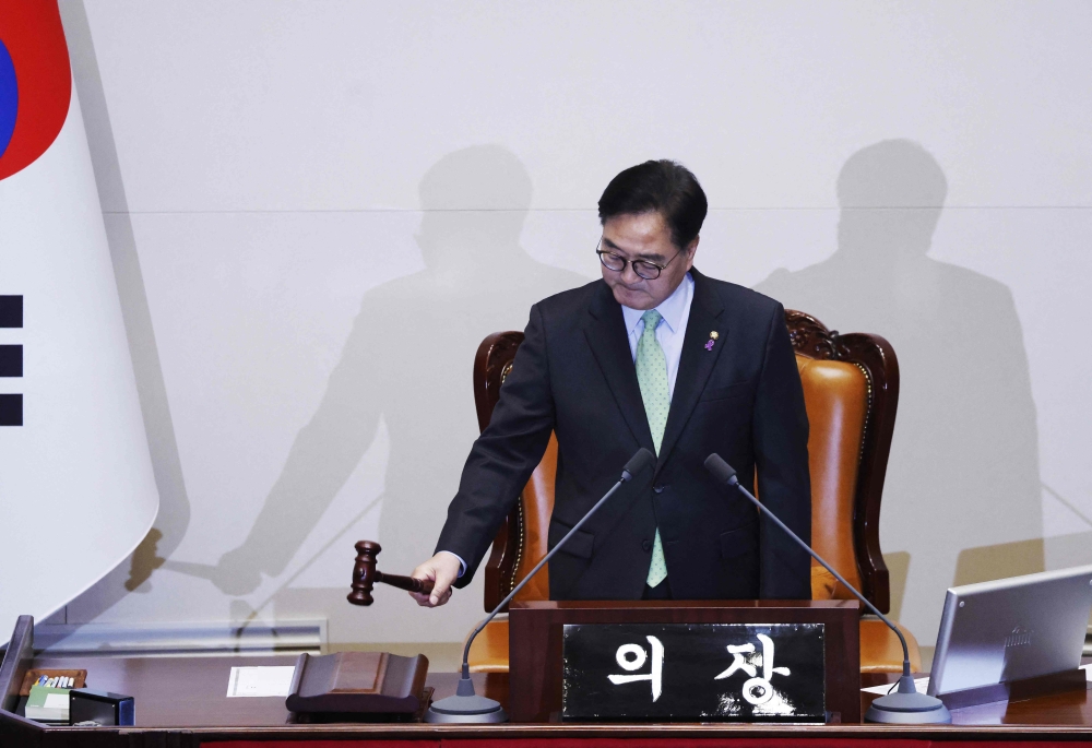 South Korean National Assembly Speaker Woo Won-shik bangs the gavel to indicate the start of the plenary session for the impeachment vote of President Yoon Suk Yeol at the National Assembly in Seoul on December 7, 2024. — Jeon Heon-kyun/Pool/AFP pic 