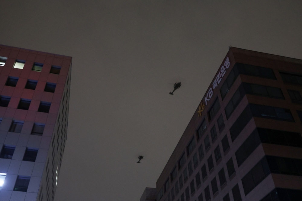 Helicopters fly, after South Korean President Yoon Suk Yeol declared martial law, in Seoul December 4, 2024. — Reuters pic  