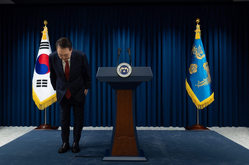 This handout photo taken and released on December 7, 2023 by the South Korean Presidential Office shows South Korea's President Yoon Suk Yeol bowing after the end of his address at the Presidential Office in Seoul. — South Korean Presidential Office handout pic via AFP 