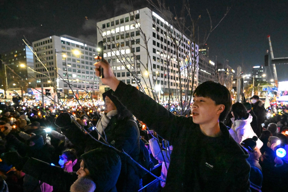 People take part in a protest calling for the ouster of South Korea President Yoon Suk Yeol outside the National Assembly in Seoul on December 7, 2024. — AFP pic