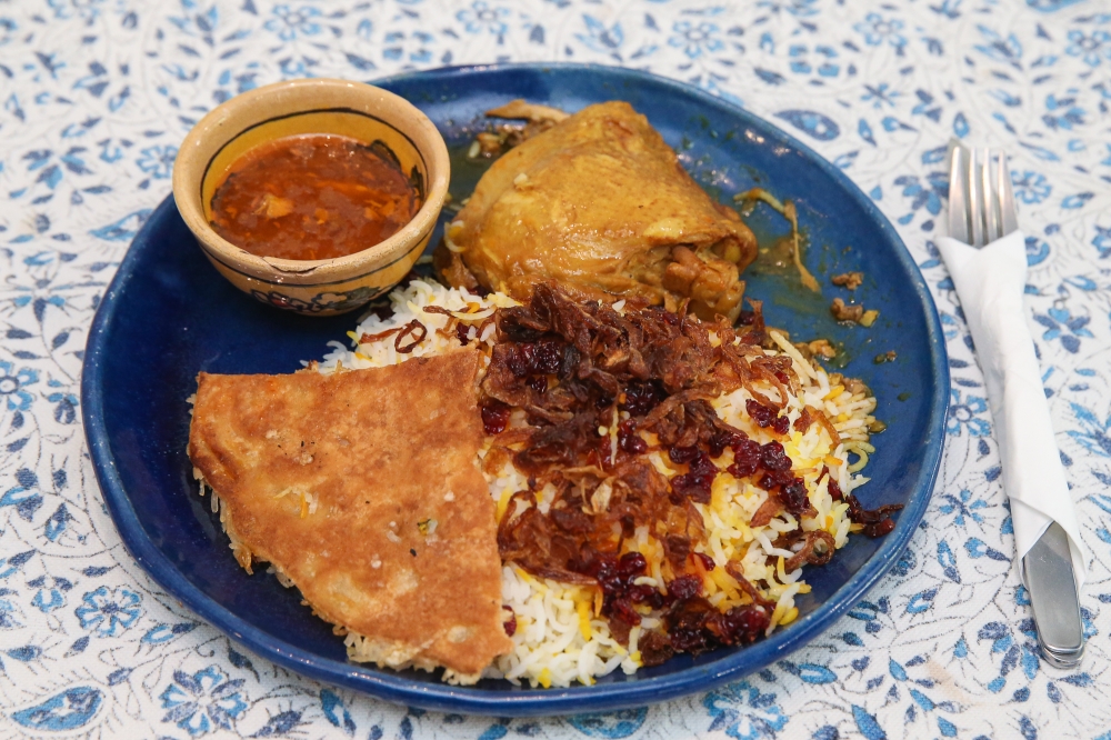 Zereshk Polo Ba Morgh, saffron chicken with caramelised barberries and rice, is one of the Tuesday lunch specials. — Picture by Yusof Mat Isa