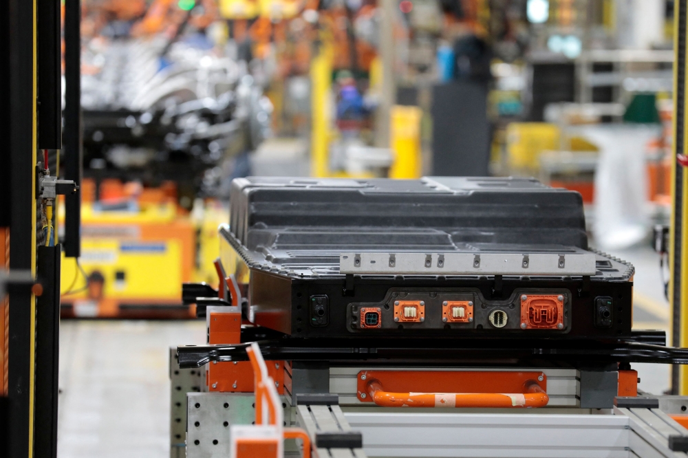 A battery waits to be installed on the frame of Ford Motor Co battery powered F-150 Lightning trucks under production at their Rouge Electric Vehicle Centre in Dearborn, Michigan September 20, 2022. China's retaliatory export controls could take a toll on the growing US clean energy sector and its defense industry, analysts say, as a trade tussle escalates between the world's two biggest economies. — AFP pic