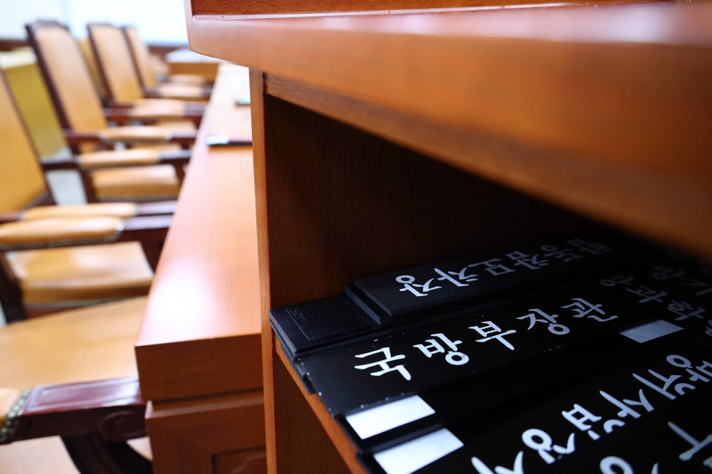 The nameplate of South Korea Defence Minister Kim Yong-hyun is seen under the podium during the plenary session of the National Defence Committee at the National Assembly in Seoul on December 5, 2024. Kim resigned today, the president’s office said, after the turmoil caused by President Yoon Suk-yeol’s brief imposition of martial law. — Yonhap/AFP pic