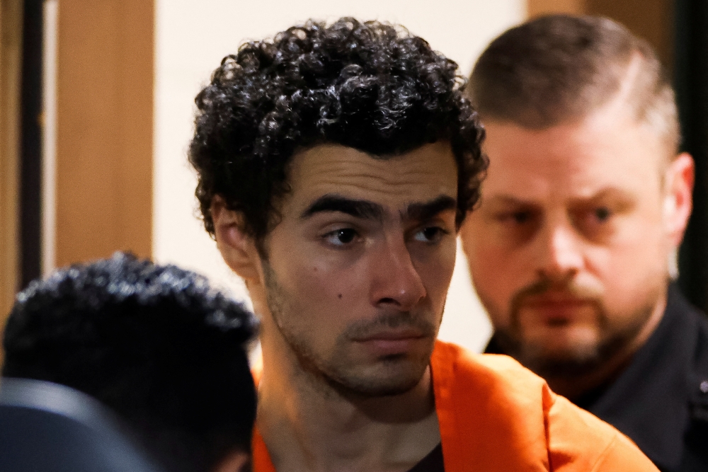 Luigi Mangione, 26, a suspect in the New York City killing of UnitedHealth executive Brian Thompson, is escorted after an extradition hearing at Blair County Court House in Hollidaysburg, Pennsylvania December 10, 2024. — Reuters pic  