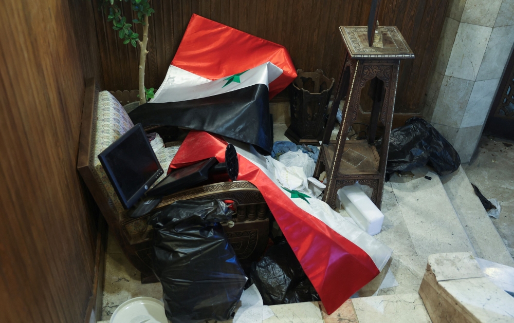 Syrian flags lie on a chair inside Damascus governorate building, after rebels seized the capital and ousted Syria's Bashar al-Assad, Syria December 11, 2024. — Reuters pic