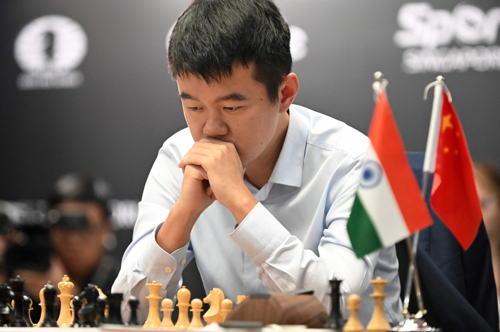 China's chess grandmaster Ding Liren competes against India's grandmaster Gukesh Dommaraju during game 14 of the 2024 FIDE World Championship in Singapore on December 12, 2024. — AFP pic