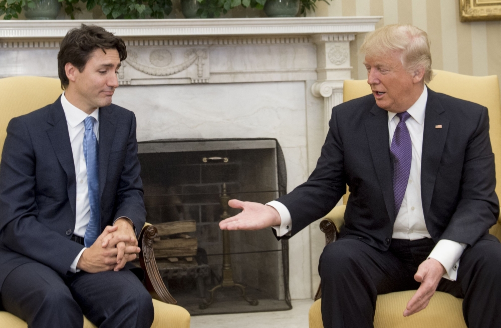 US President Donald Trump and Canadian Prime Minister Justin Trudeau shake hands during a meeting in the Oval Office of the White House in Washington, DC, on February 13, 2017. — AFP pic