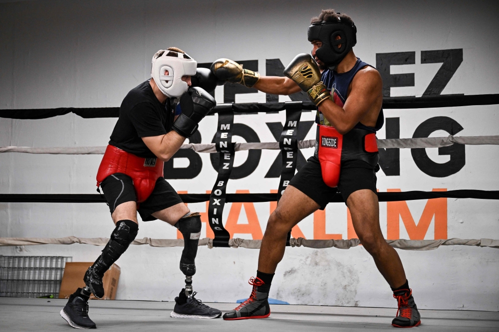 Boxer Pierre-Mickael Hugues (left) trains with professional boxer Christophe Mendy at Mendez Boxing Gym Harlem December 5, 2024 in New York City. Because of a lack of funding in his native France, Hugues hopes to find financing for his passion while in the United States and turn professional within two years. — AFP pic