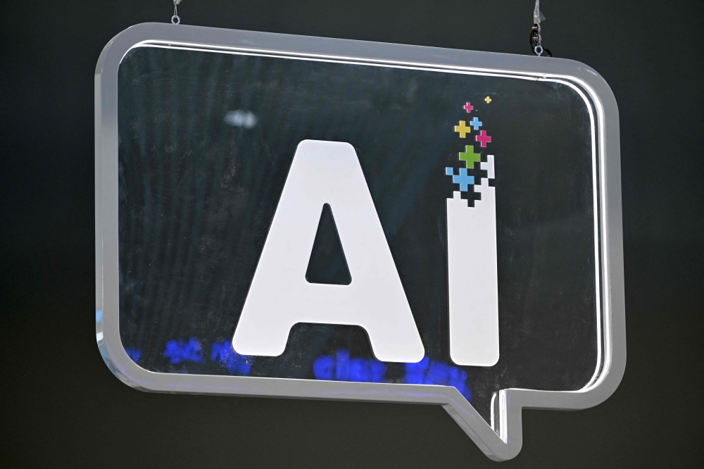 This photograph shows an AI (artificial intelligence) logo at the Mobile World Congress (MWC), the telecom industry's biggest annual gathering, in Barcelona on February 27, 2024. Apps infused with AI are being marketed to schools across the world and governments are rushing to embrace the technology, despite experts raising serious doubts. — AFP pic