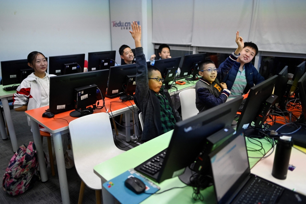 This picture taken on November 8, 2019 shows pupils attending a class at a children's computer coding training centre in Beijing. — AFP pic