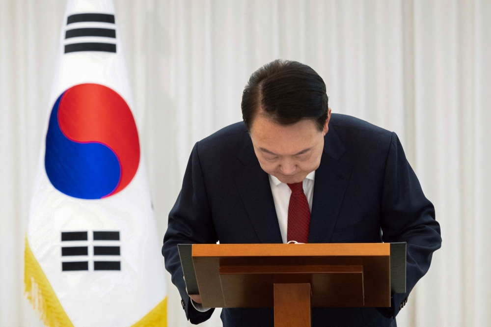 This handout from the South Korean Presidential Office via Yonhap taken and released on December 14, 2024 shows President Yoon Suk Yeol giving a public address from his official residence in Seoul. — South Korean Presidential Office handout pic via Yonhap/AFP