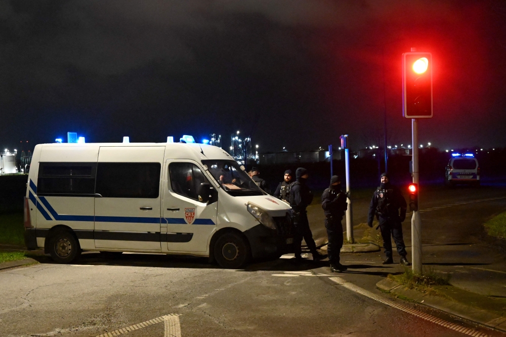 French CRS Police (Republican Security Companies) block off a road near a migrant camp where two security guards and two migrants were shot dead, near Dunkirk, northern France, on December 14, 2024. — AFP pic