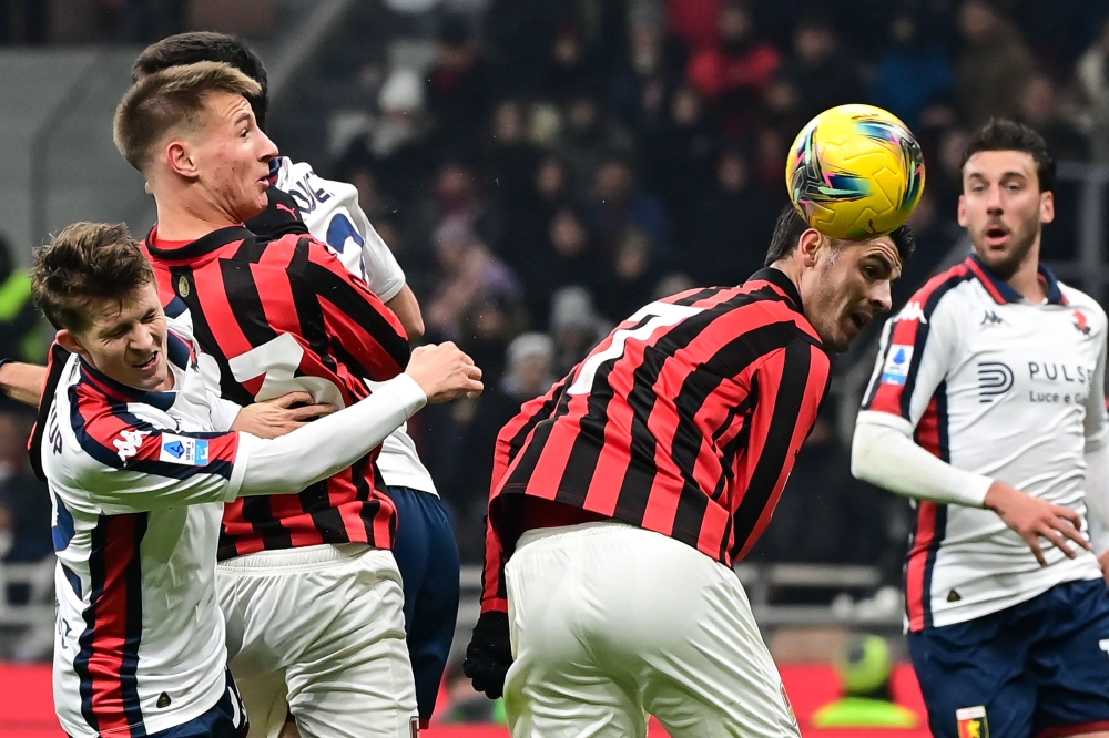 AC Milan's Spanish forward Alvaro Morata (second right) heads the ball during the Italian Serie A football match between AC Milan and Genoa at the San Siro Stadium in Milan, on December 15, 2024. — AFP pic