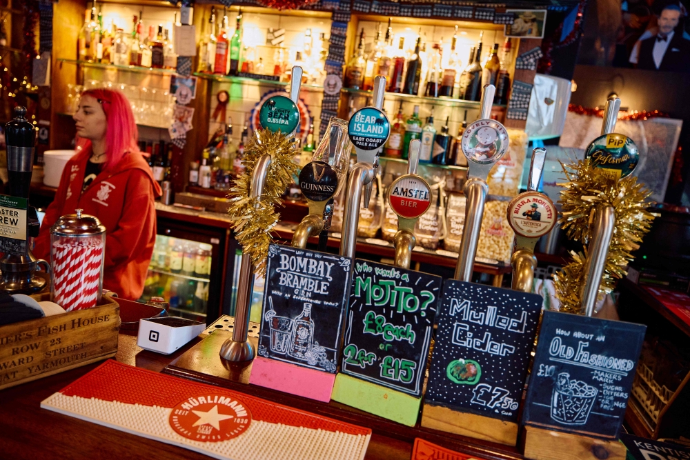 A selection of beers are seen available at the bar inside The Old Ivy House public house in Clerkenwell, London December 15, 2024, with the glass on the Guinness tap indicating the tap not in use due to the drink being unavailable. — AFP pic