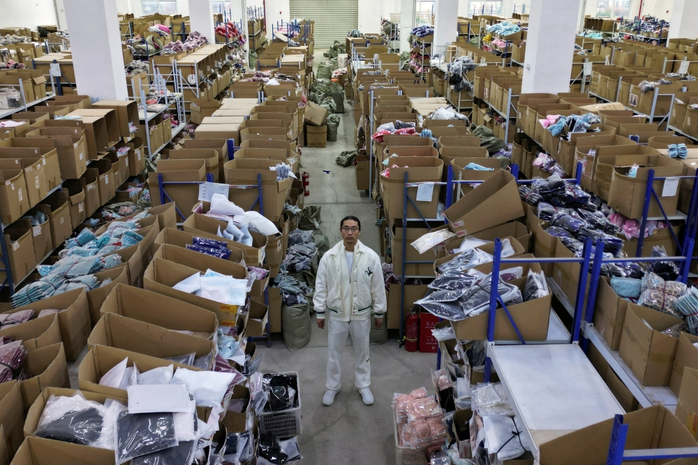 A drone view shows Lei Congrui posing for pictures at the warehouse of his Midnight Charm Garment lingerie factory in Guanyun county of Lianyungang, Jiangsu province, China November 25, 2024. — Reuters pic