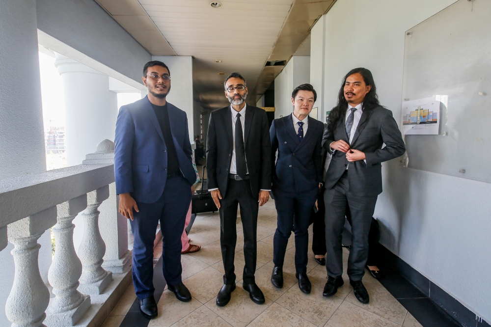 Film director Khairi Anwar Jailani (left) and ‘Mentega Terbang’ producer Tan Meng Kheng (second, right) are seen with lawyers N. Surendran (second, left) and Zaid Malek (right) at the Kuala Lumpur High Court Complex May 10, 2024. ― Picture by Hari Anggara