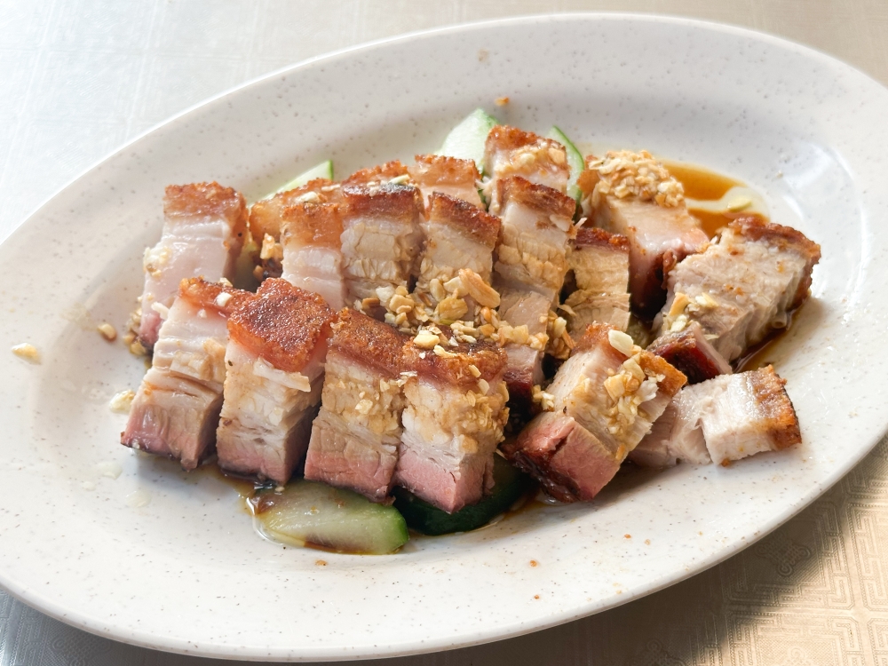 Hong Kong Taste Chicken Rice's crispy roast pork has a beautiful golden crackling with uneven layers of fat and meat. — Picture by Lee Khang Yi