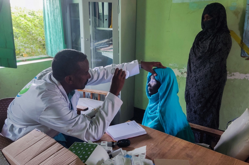 A Sudanese doctor performs a medical check on a patient at a hospital in Tokar in the Red Sea State following recent heavy flooding in eastern Sudan on October 10, 2024. — AFP pic 