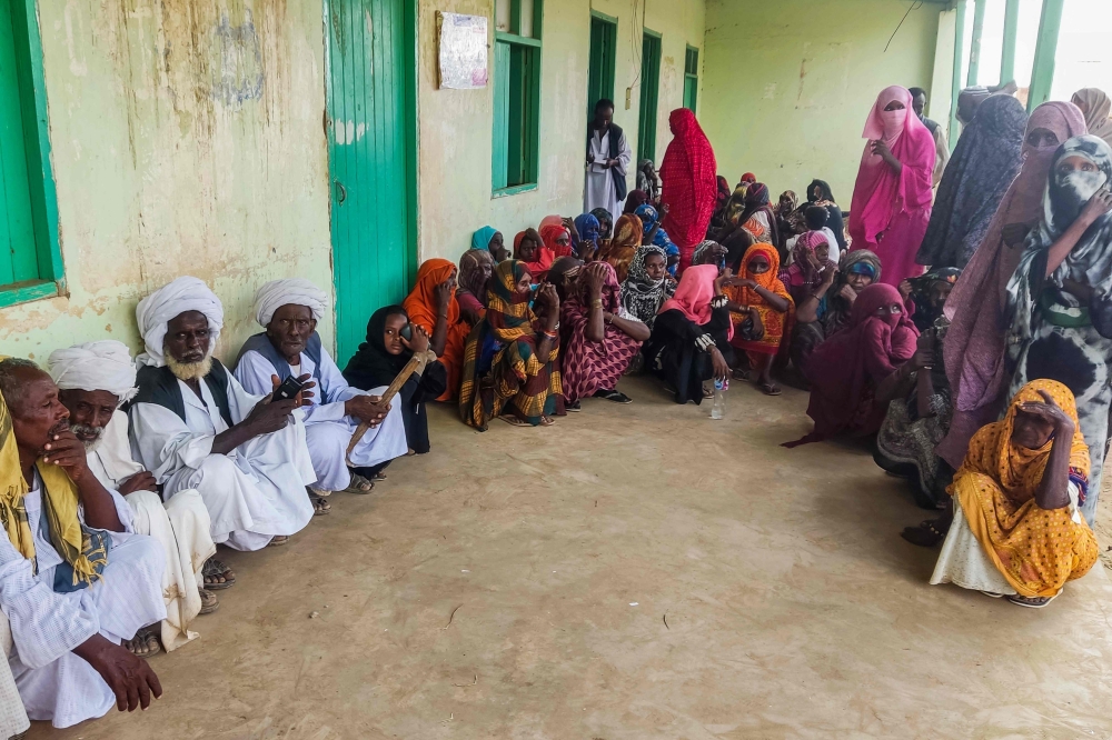 Sudanese wait outside a hospital for medical check-up in Tokar in the Red Sea State following recent heavy flooding in eastern Sudan on October 10, 2024. — AFP pic 