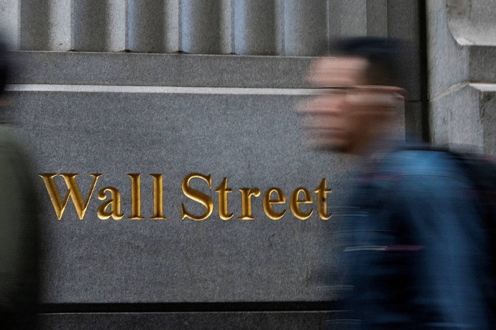 People walk around the New York Stock Exchange in New York December 29, 2023. The ongoing confusion caused by the Republican leader is already a headache for journalists, diplomats, politicians and financial players. — Reuters pic  