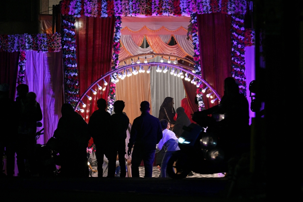 In this photograph taken on December 15, 2024, people attend a wedding in New Delhi. Elaborate Indian weddings are big business, and for some families the first step of celebration is not to call a priest or a party planner — but a private detective. — AFP pic