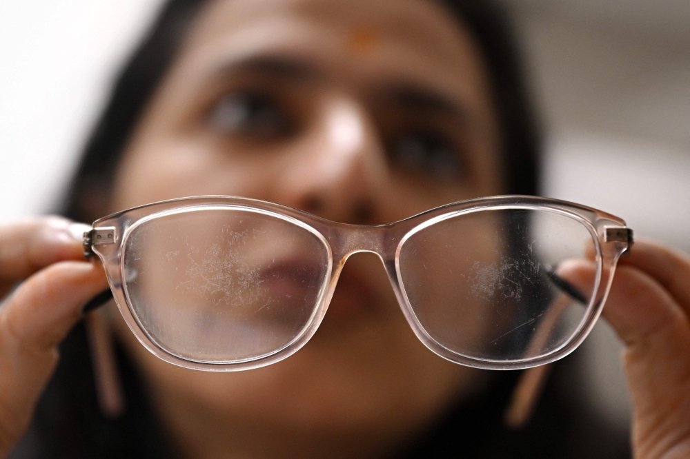 In this photograph taken on December 7, 2024, Akriti Khatri, founder of Venus Detective Agency, shows spectacles with a hidden spy camera during an interview with AFP in New Delhi. — AFP pic