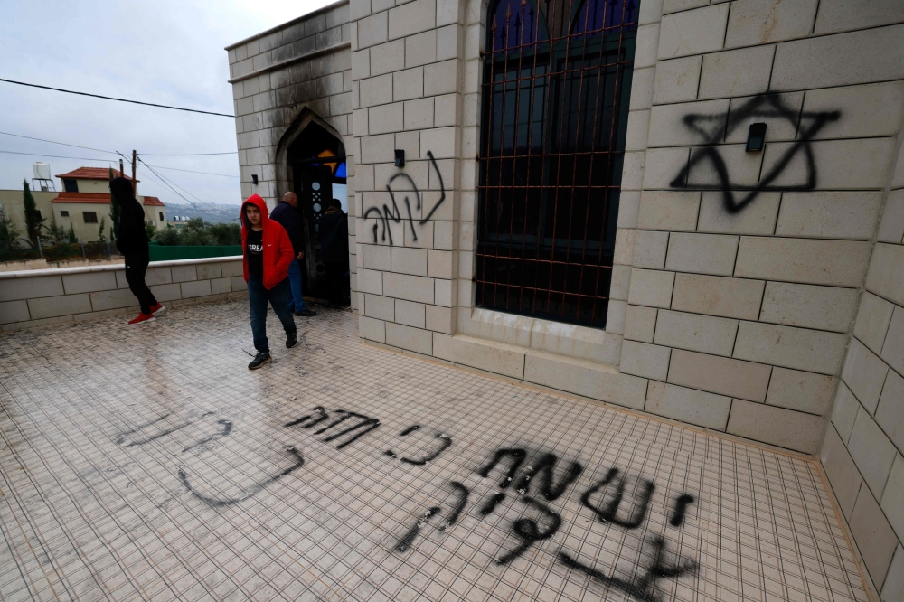 Palestinians inspect the damage done to a mosque, after a reported attack by Israeli settlers, in the town of Marda near the West Bank city of Salfit on December 20, 2024. — AFP pic