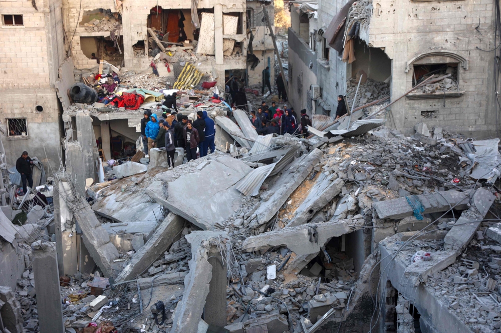 People look for survivors following an Israeli strike in the al-Daraj neighbourhood in Gaza City on December 19, 2024. — AFP pic