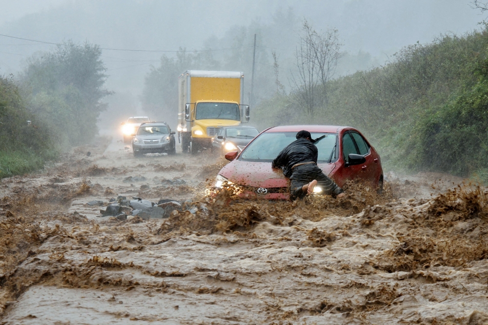 Relentless global warming provoked heatwaves, droughts and deadly flooding, with the wet weather proving particularly dramatic. — Reuters pic