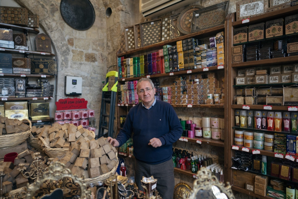 Fadel Fadel, a 61-year-old shopkeeper, poses inside his stall at a traditional market area in Aleppo on December 17, 2024. — AFP pic