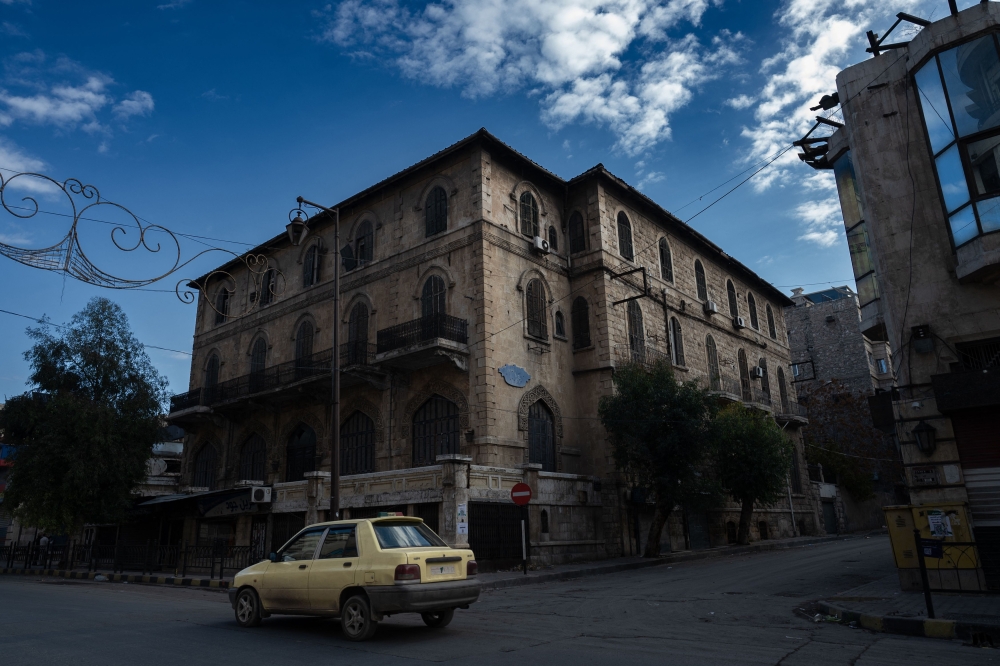 A car drives past the Baron Hotel in Aleppo on December 13, 2024. — AFP pic