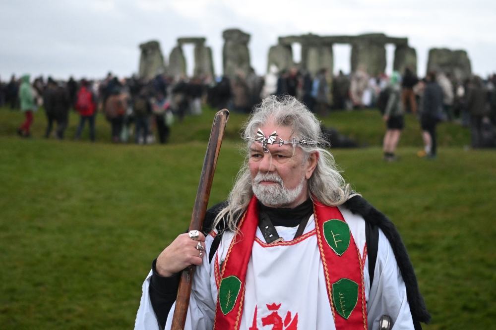 Druid, Arthur Pendragon look on as people gather to celebrate the pagan festival of 'Winter Solstice' at Stonehenge in Wiltshire in southern England on December 21, 2024. — AFP pic