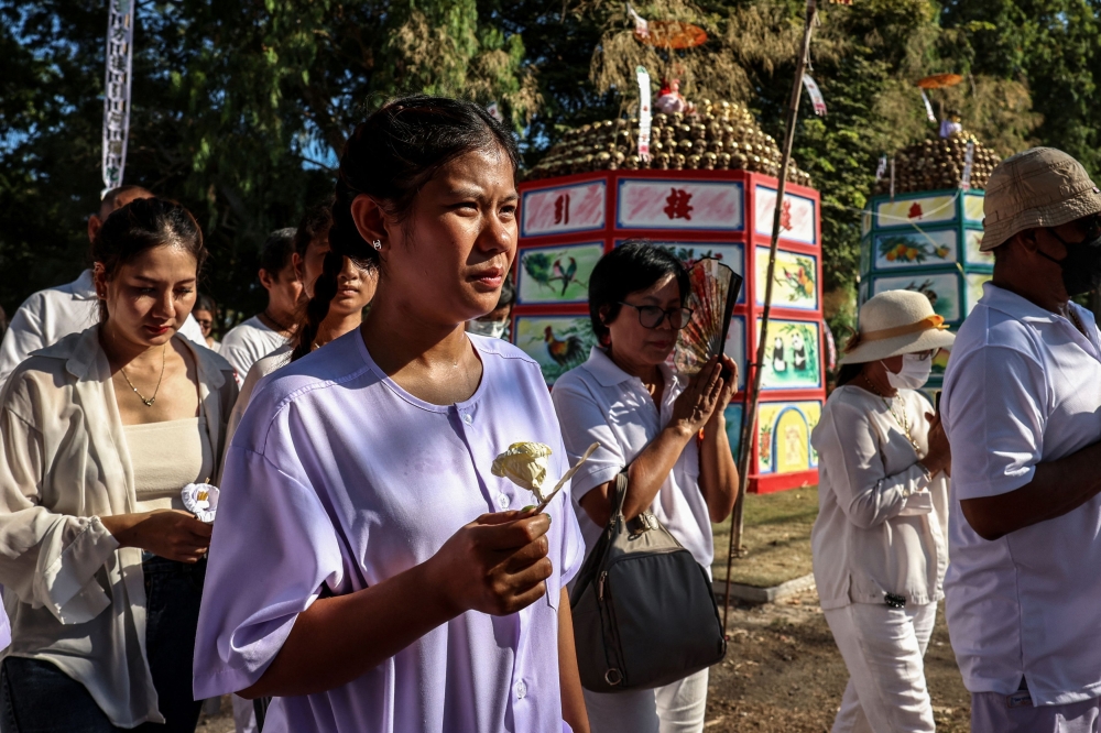 Paikaew Thaijaroen, 26, mother of two-month-old Bibeam who lost her life in November 2023, walks three rounds and pays her respects near funeral pyres on the cremation day. — Reuters