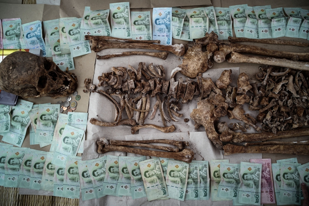 Bank notes are laid beside an unclaimed body after the remains were dug out from a graveyard. — Reuters