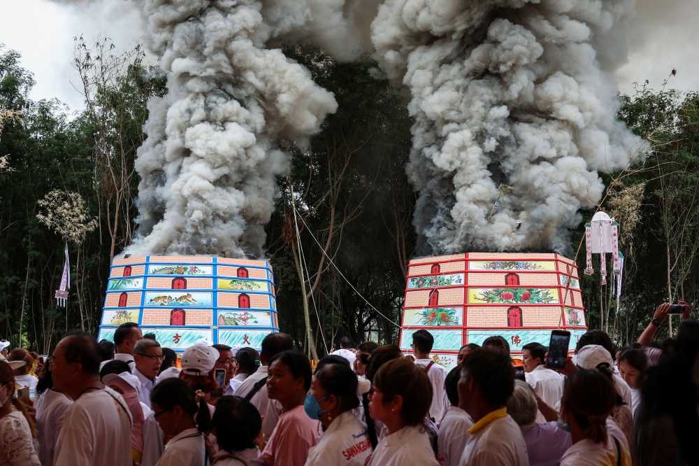 Smoke rises from funeral pyres. — Reuters