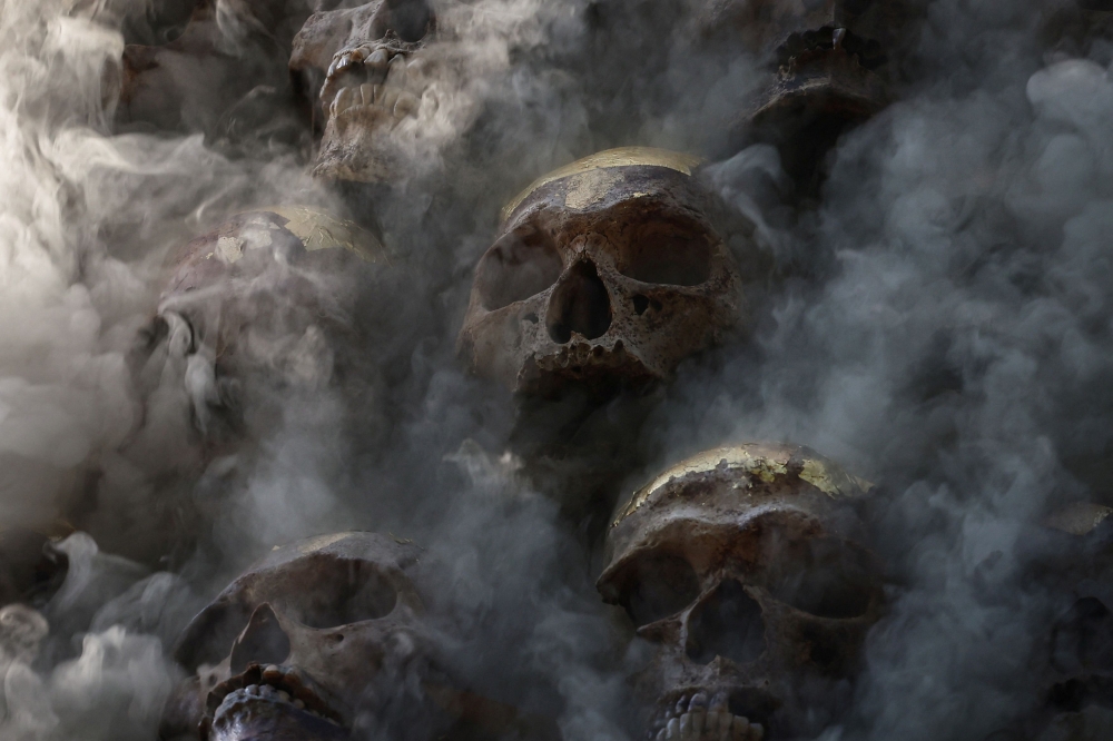 A pile of human skulls burn after a funeral pyre was lit. — Reuters