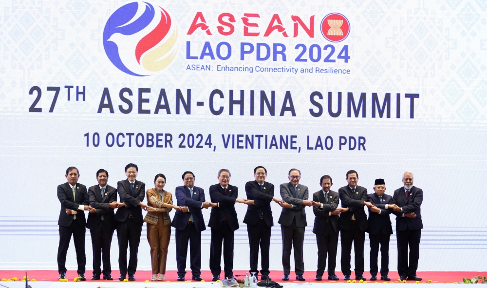 Leaders stand for a group photo during the 27th Asean-China Summit at the National Convention Centre in Vientiane October 10, 2024. — Reuters pic