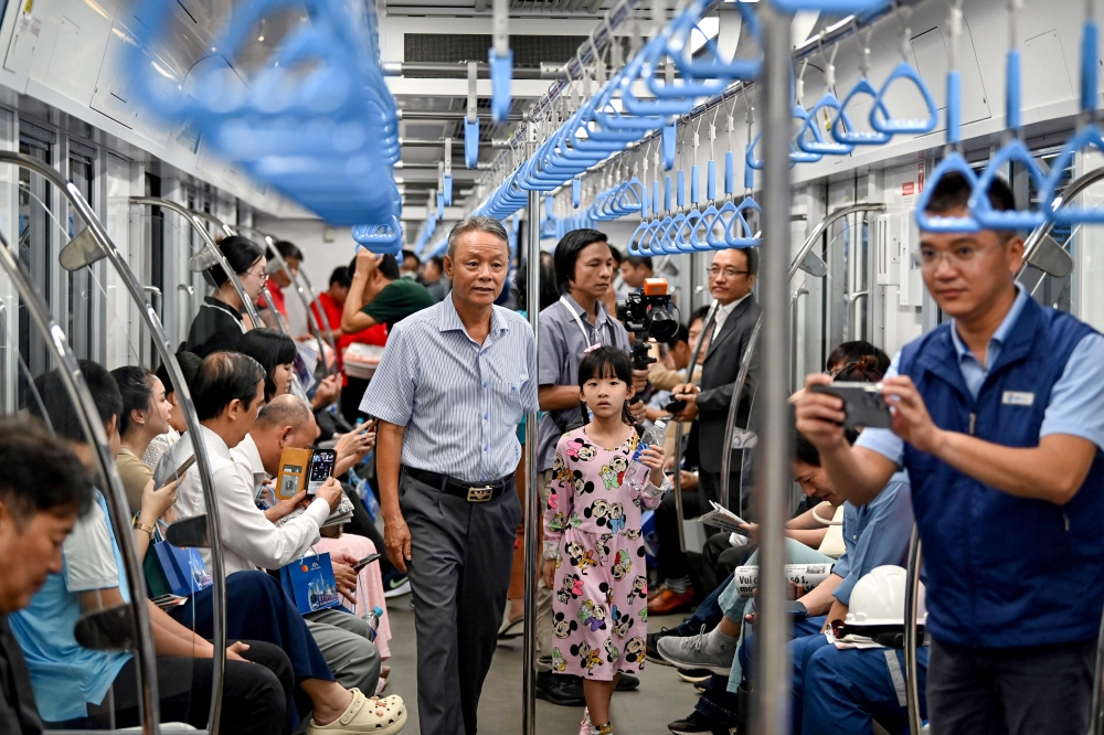 Thousands of selfie-taking Ho Chi Minh City residents crammed into train carriages Sunday as the traffic-clogged business hub celebrated the opening of its first-ever metro line after years of delays. — AFP pic